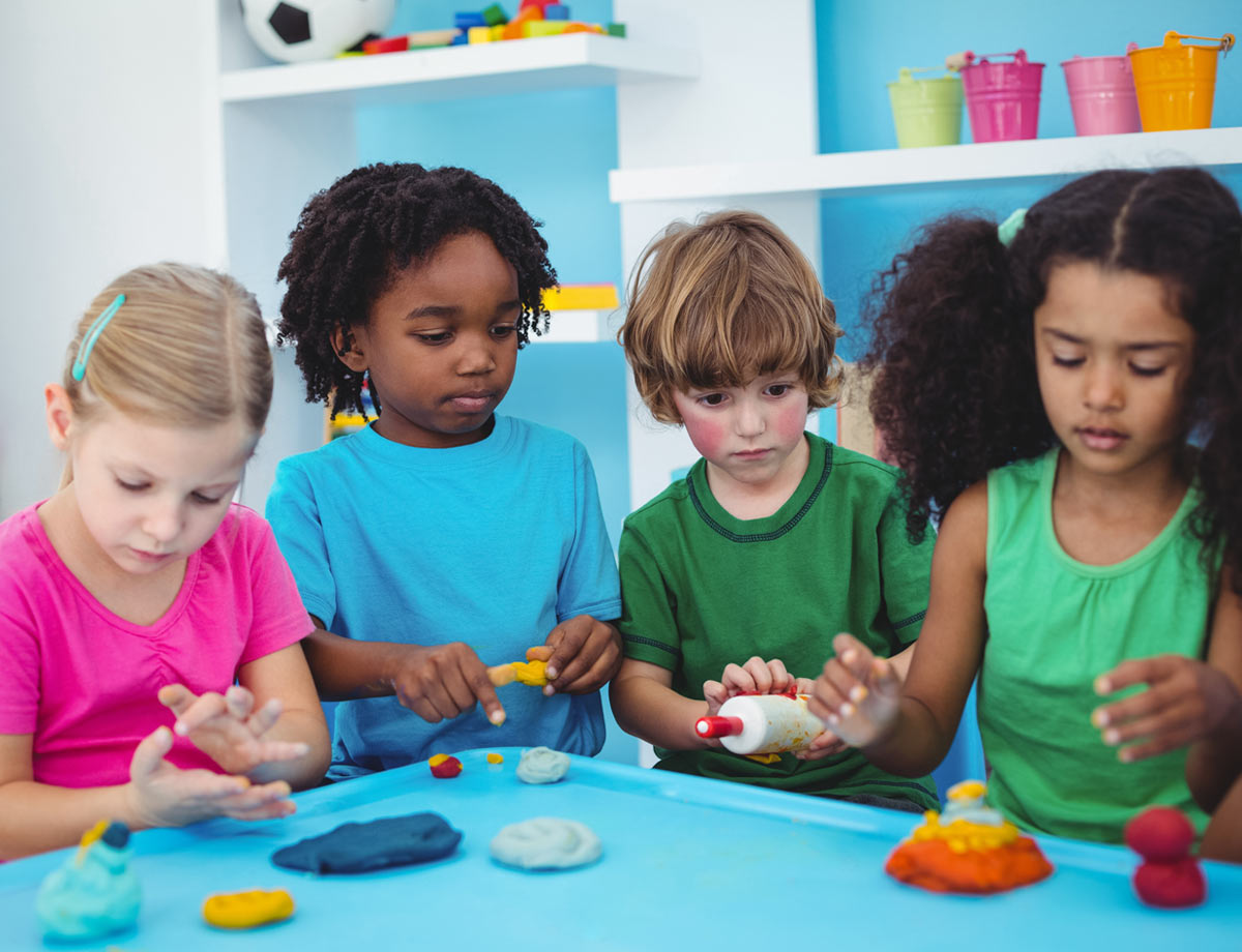 four children playing with playdoh